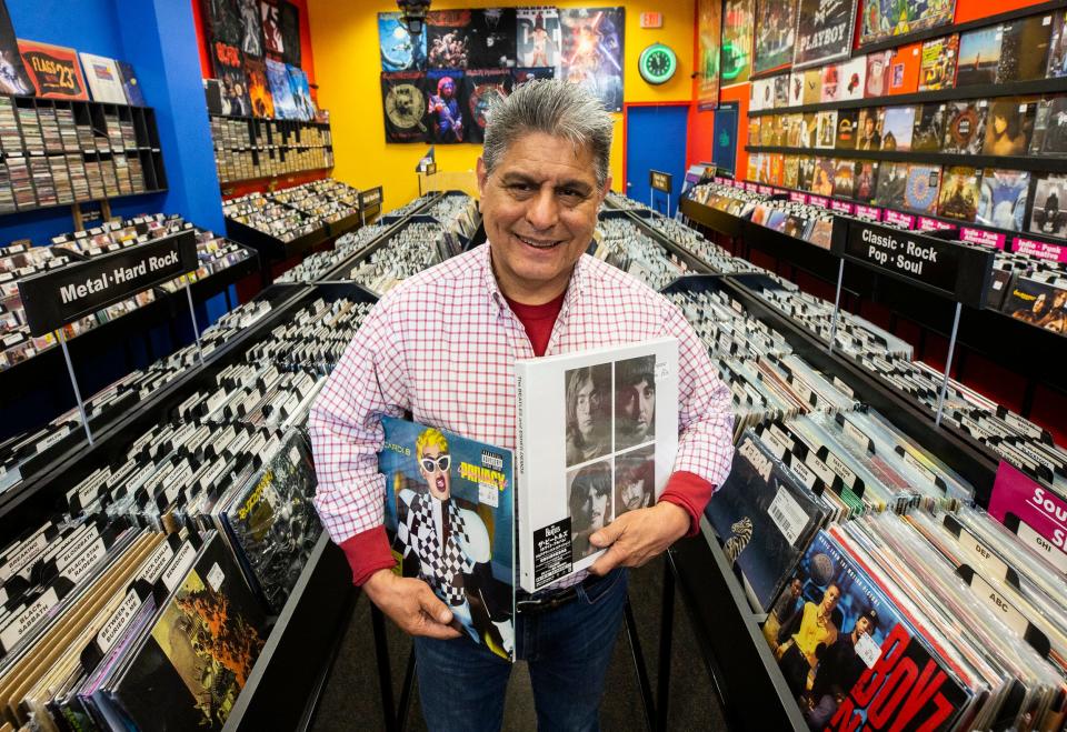 George Reynoso, owner of All That Music & Video, is photographed at his store at The Fountains at Farah. The store will double in size.