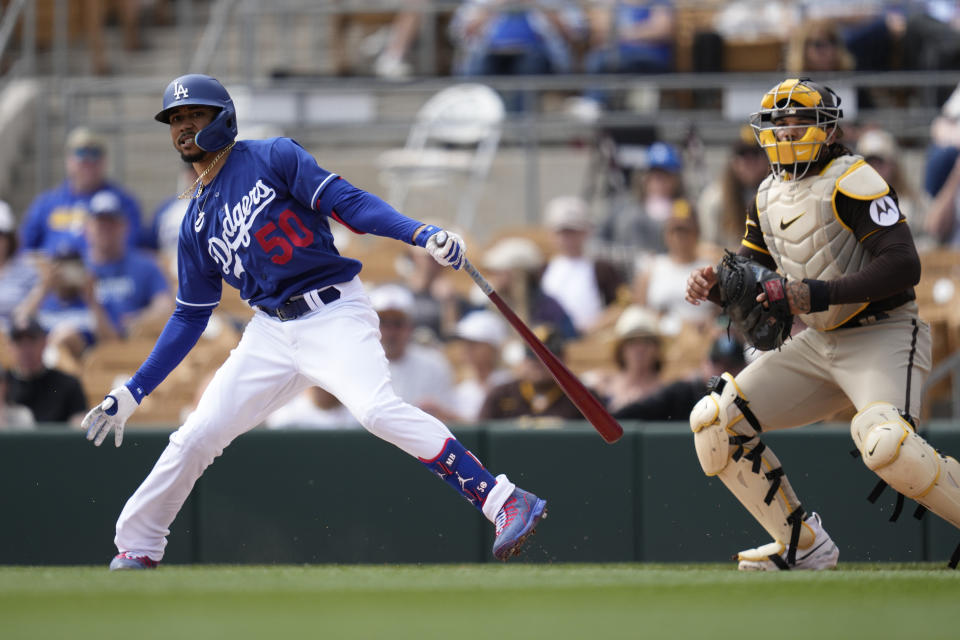 Los Angeles Dodgers' Mookie Betts (50) reacts to hitting a foul ball during the first inning of a spring training baseball game against the San Diego Padres in Glendale, Calif., Monday, March 6, 2023. (AP Photo/Ashley Landis)