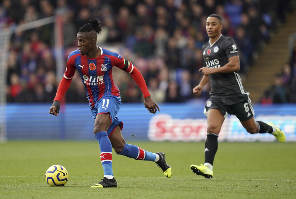 Crystal Palace's Wilfried Zaha, left, breaks from Leicester City's Youri Tielemans during the English Premier League soccer match at Selhurst Park, London, Sunday Nov. 3, 2019. (John Walton/PA via AP)