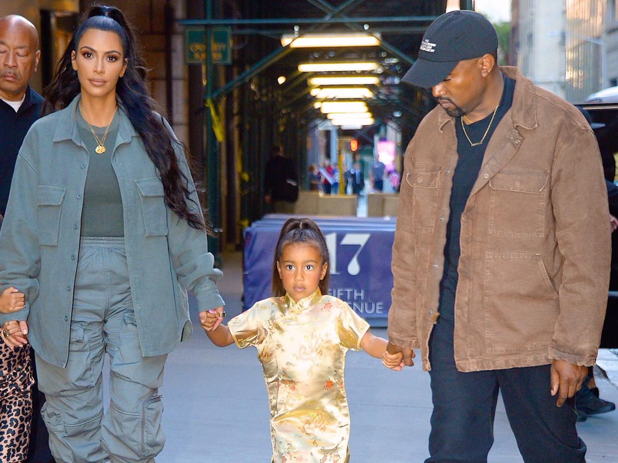 Kim Kardashian, Kanye West, and their daughter North West in 2018.