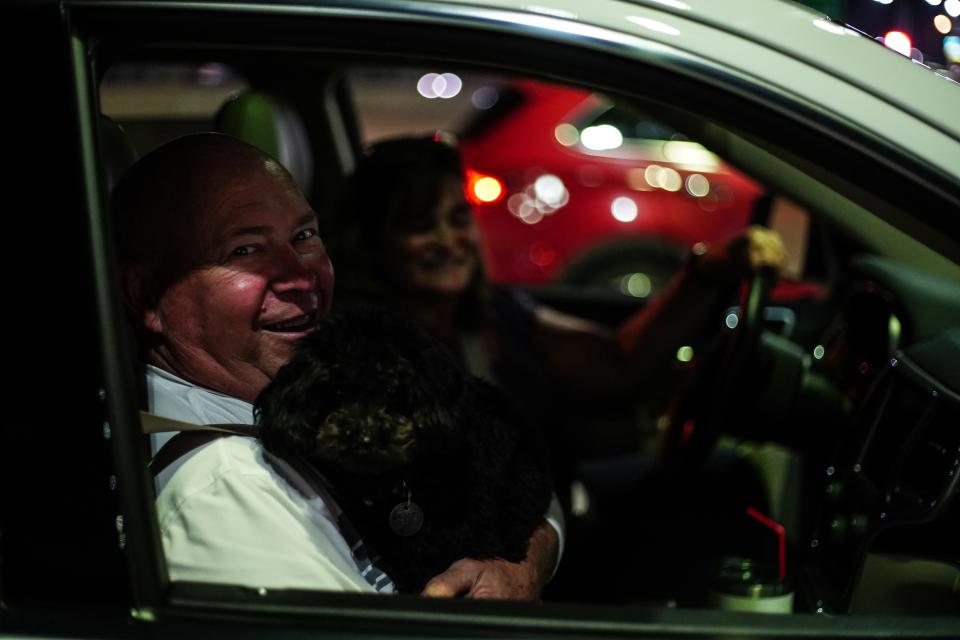 David Bruns, 63, and his wife Carolyn Ferroni, 62 of Columbus, Ohio with their dog, Ziggy, stop at the Duty Free store before they cross the Ambassador bridge in Detroit on Monday, August 9, 2021. Canada opened its borders to the United States, allowing for fully vaccinated U.S. citizens and permanent residents to cross the border on Monday, Aug. 8, 2021.