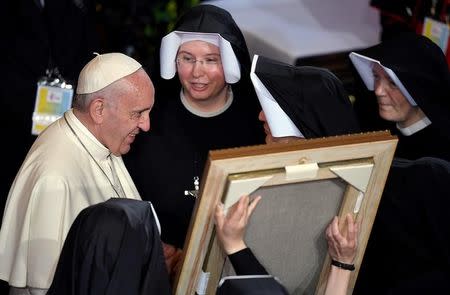 Pope Francis is greeted by nuns during a visit at the Sanctuary of Divine Mercy in Krakow, Poland July 30, 2016. REUTERS/Daniel Dal Zennaro/Pool