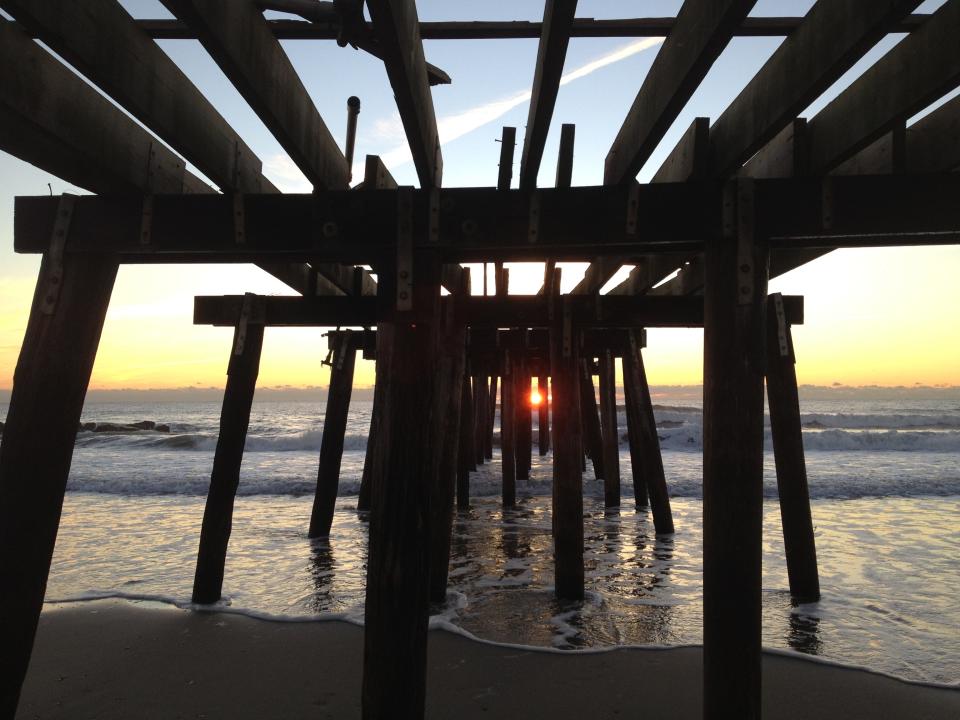 The damaged Ocean Grove Pier at sunrise several days after Superstorm Sandy struck.