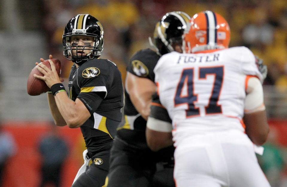 Missouri quarterback Blaine Gabbert, left, looks to throw as Illinois defensive tackle Glenn Foster (47) defends during the second quarter of an NCAA college football game Saturday, Sept. 4, 2010, in St. Louis.