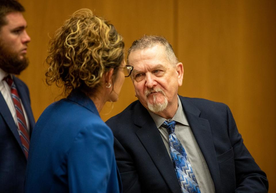 David Murdock talks with defense attorney Debra Tuomey during his first-degree murder trial in Bartow on Monday.