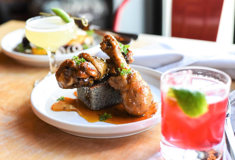 Valencia Wings, foreground, and blood orange salad, background, are two of the dishes on Cardinal Spirit's new spring menu of dishes and cocktails.