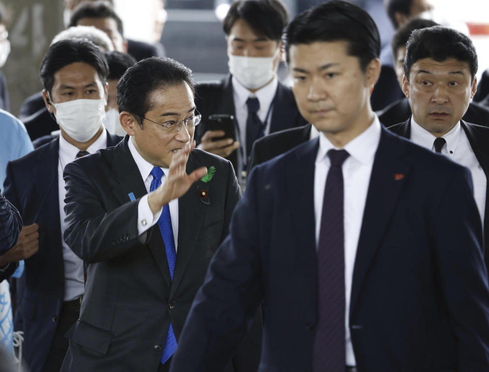Japanese Prime Minister Fumio Kishida, left, surrounded by security police, arrives at the Saikazaki port for an election campaign event in Wakayama, western Japan Saturday, April 15, 2023. Kishida was evacuated unharmed Saturday after someone threw an explosive device in his direction while he was campaigning at the fishing port in western Japan, officials said.(Kyodo News via AP)