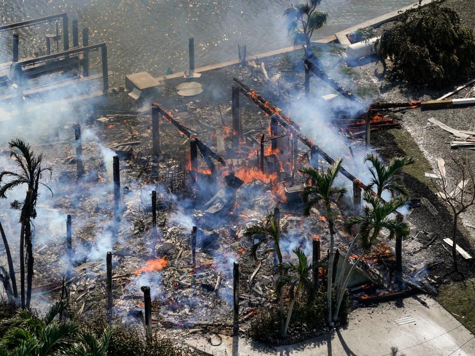 Smoldering homes are seen in the aftermath of Hurricane Ian, Thursday, Sept. 29, 2022, in Fort Meyers Beach. Fla.