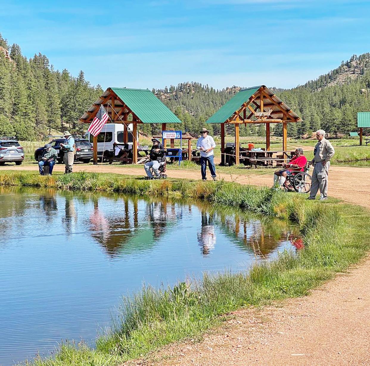 Project Healing Waters volunteers work with disabled veterans from Pueblo during a fishing outing in Woodland Park June 7, 2023.