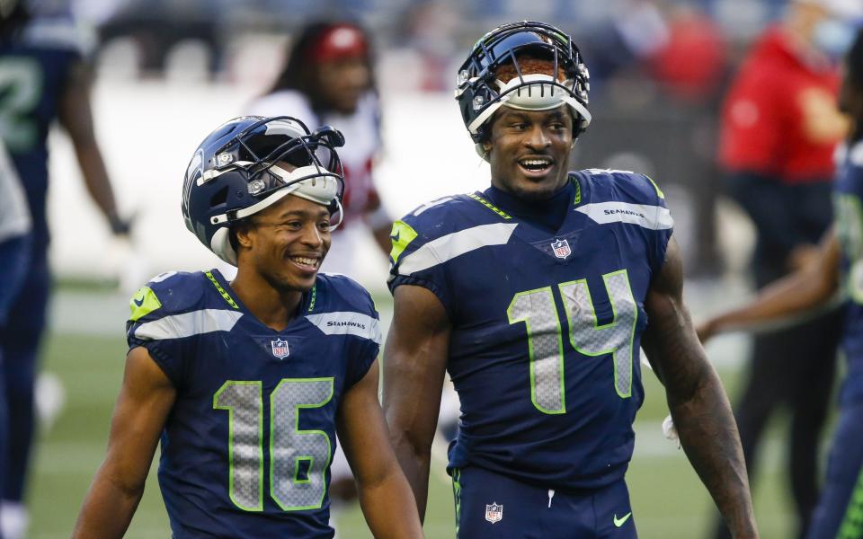 Nov 1, 2020; Seattle, Washington, USA; Seattle Seahawks wide receiver Tyler Lockett (16) and wide receiver DK Metcalf (14) return to the locker room following a 37-27 victory against the San Francisco 49ers at CenturyLink Field. Mandatory Credit: Joe Nicholson-USA TODAY Sports