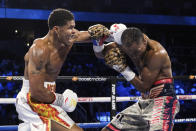 Shakur Stevenson, left, lands a punch on Jamel Herring during a junior lightweight boxing bout in Atlanta on early Sunday, Oct. 24, 2021. Stevenson won the bout. (AP Photo/Ben Gray)