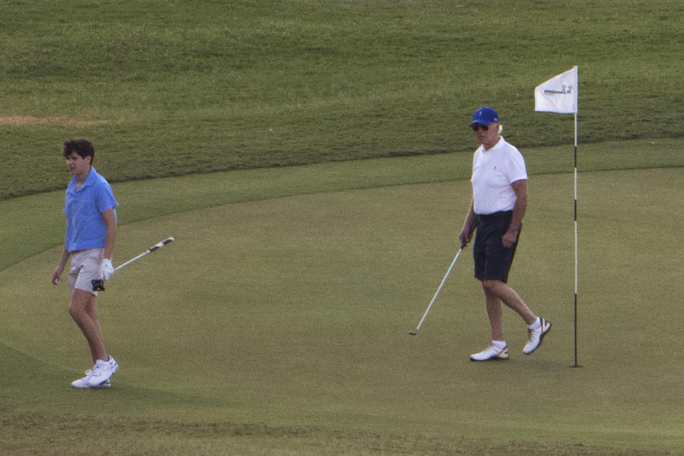 President Joe Biden plays golf with grandson Hunter Biden, left, at The Buccaneer in Christiansted, U.S. Virgin Islands, Friday, Dec. 30, 2022. (AP Photo/Manuel Balce Ceneta)