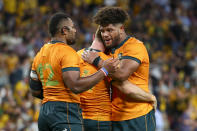Australia's Samu Kerevi, left, Rob Valetini, right, and Andrew Kellaway celebrate after defeating South Africa in their Rugby Championship test match between the Springboks and the Wallabies in Brisbane, Australia, Saturday, Sept. 18, 2021. (AP Photo/Tertius Pickard)