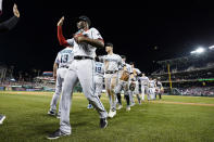 Miami Marlins' Jesus Sanchez, front, celebrates with teammates after a baseball game against the Washington Nationals at Nationals Park, Friday, July 1, 2022, in Washington. The Marlins won 6-3. (AP Photo/Alex Brandon)