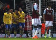 Arsenal's Theo Walcott (3rd L) celebrates with team mates after scoring a goal against West Ham United during their English Premier League soccer match at the Boleyn Ground in London December 26, 2013. REUTERS/Suzanne Plunkett