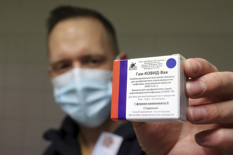 A pharmacist holds a packet of Sputnik V vaccines to be used for the first dose in the pharmacy of the Borsod-Abauj-Zemplen County Medical Center and University Teaching Hospital in Miskolc, Hungary, Tuesday, March 9, 2021. (Janos Vajda/MTI via AP)