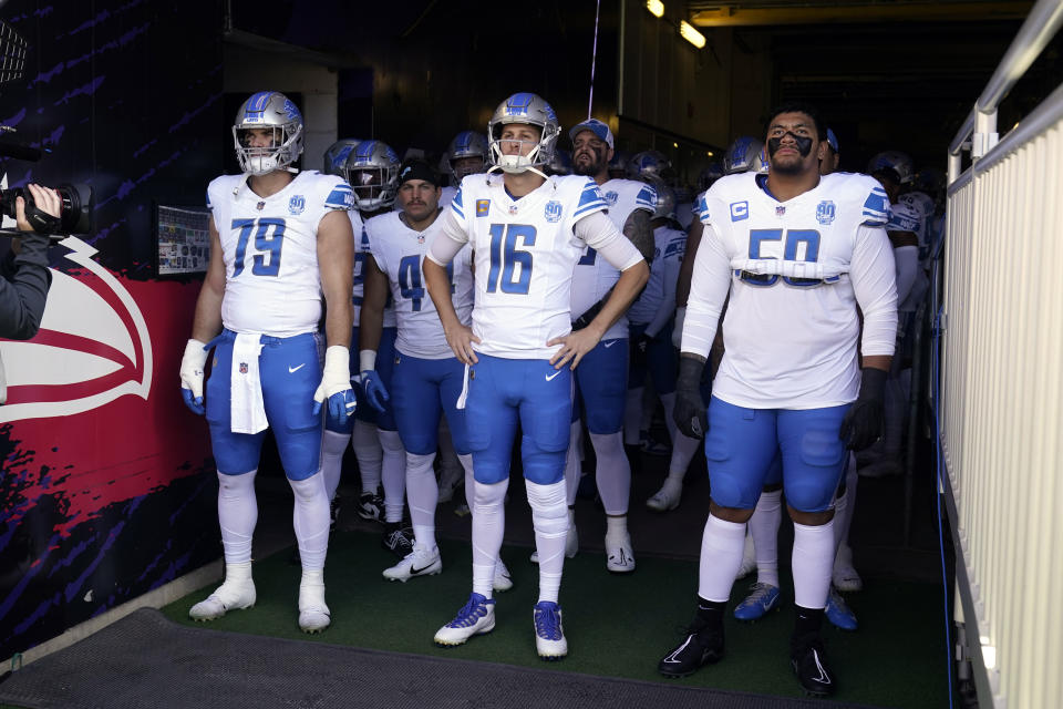 Detroit Lions defensive end John Cominsky (79), quarterback Jared Goff (16) and offensive tackle Penei Sewell (58) and teammates wait to enter the field before an NFL football game against the Baltimore Ravens, Sunday, Oct. 22, 2023, in Baltimore. (AP Photo/Alex Brandon)