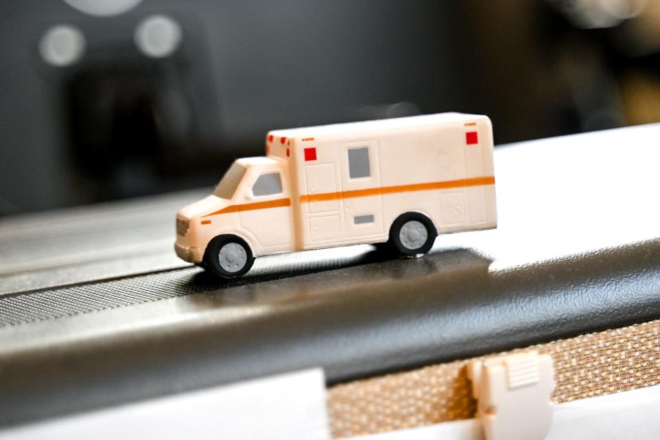 A mini ambulance is displayed at a 911 operator's desk at Ingham County's 911 Center on Wednesday, April 26, 2023, in Lansing.