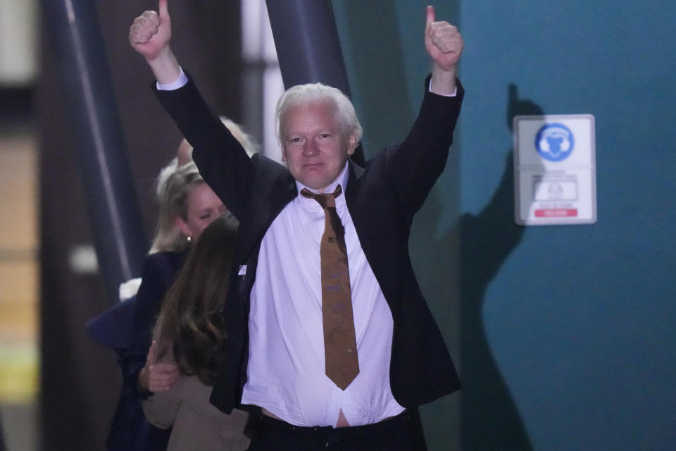 WikiLeaks founder Julian Assange gestures after landing at RAAF air base Fairbairn in Canberra, Australia, Wednesday, June 26 2024. Assange has returned to his homeland Australia aboard a charter jet hours after pleading guilty to obtaining and publishing U.S. military secrets in a deal with Justice Department prosecutors that concludes a drawn-out legal saga.(AP Photo/Rick Rycroft)