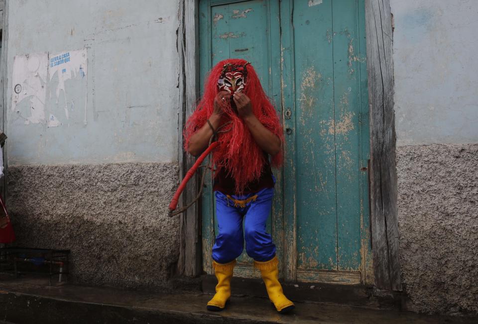 A man dressed up as the devil participates in La Diablada in Pillaro, Ecuador, Monday, Jan. 6, 2014. The feast celebrates the end of the year and start the new one. The town of Pillaro kicks off the feast of the La Diablada with neighborhoods competing to bring as many people dressed as different characters. Originally the devil costume was used to open up space to allow other participants to dance, but over the years the character gained popularity and became the soul of the feast. (AP Photo/Dolores Ochoa)