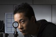 University of Rochester Ph.D. student Joseph Choi demonstrates a cloaking device using four lenses in Rochester, New York in this September 11, 2014 University of Rochester handout photo. REUTERS/J. Adam Fenster/University of Rochester/Handout via Reuters