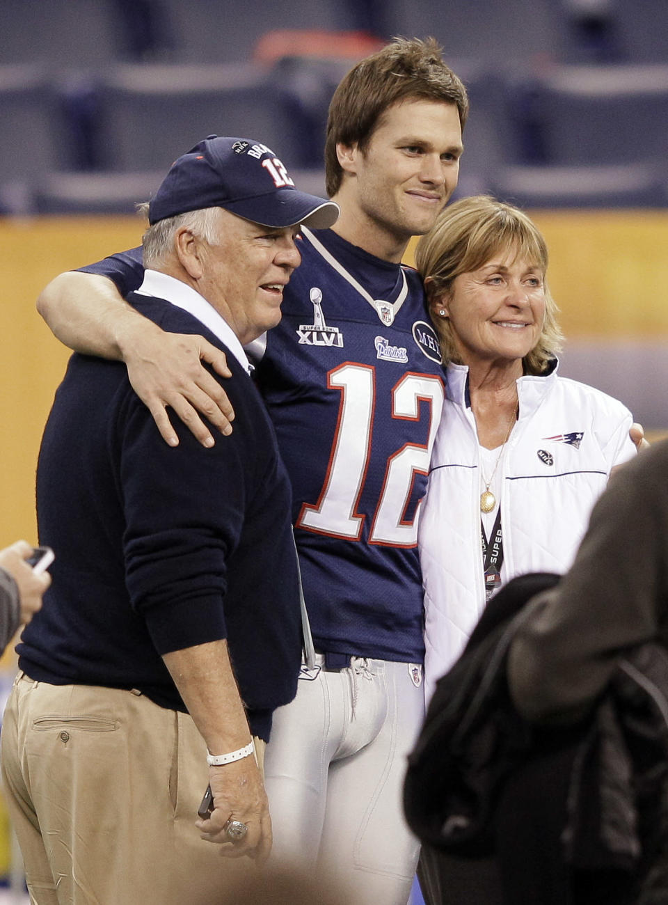 New England Patriots quarterback Tom Brady (12) poses for a photo with his parents, Tom and Galynn Brady, in Lucas Oil Stadium on Saturday, Feb. 4, 2012, in Indianapolis. The Patriots are scheduled to face the New York Giants in NFL football Super Bowl XLVI on Feb. 5. (AP Photo/Mark Humphrey)