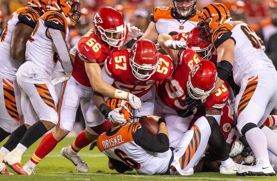 Chiefs linebackers Ben Niemann (56) and Breeland Speaks (57) and defensive tackle Joey Ivie (93) apply the crunch to Bengals quarterback Jeff Driskel Saturday at Arrowhead Stadium.