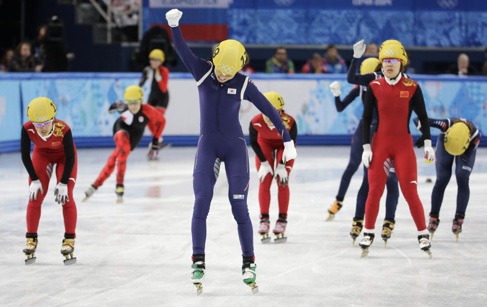 Shim Suk-Hee of South Korea, center, celebrates her team's first place in the women's 3000m short track speedskating relay final at the Iceberg Skating Palace during the 2014 Winter Olympics, Tuesday, Feb. 18, 2014, in Sochi, Russia. (AP Photo/David J. Phillip, File)