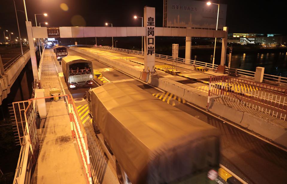 Trucks carrying soldiers from China's People's Liberation Army (PLA) pass through the Huanggang Port border between China and Hong Kong.