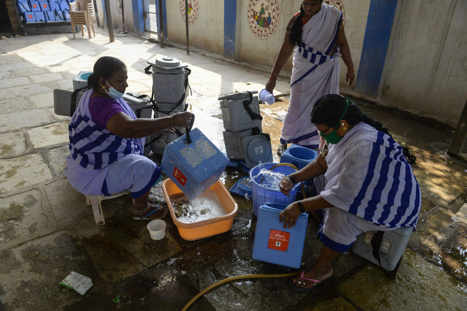 ASHA workers clean carriers for the COVID-19 vaccine at a health center in Hyderabad on Jan. 29, 2021.<span class="copyright">Noah Seelam—AFP/Getty Images</span>