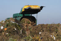 A truck unloads organic waste to be used for composting at the Anaerobic Composter Facility in Woodland, Calif., Tuesday, Nov. 30, 2021. In January 2022, new rules take effect in California requiring people to recycle organic waste like food and cardboard boxes so they can be turned into compost or energy. The goal is to reduce greenhouse gas emissions from landfills.(AP Photo/Rich Pedroncelli)