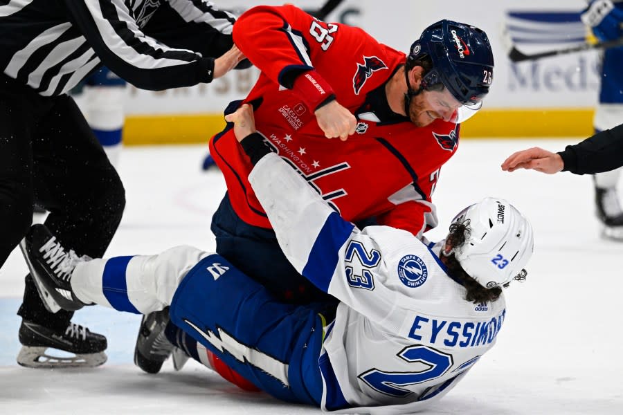 Washington Capitals center Nic Dowd (26) fights with Tampa Bay Lightning center <a class="link " href="https://sports.yahoo.com/nhl/players/7248/" data-i13n="sec:content-canvas;subsec:anchor_text;elm:context_link" data-ylk="slk:Michael Eyssimont;sec:content-canvas;subsec:anchor_text;elm:context_link;itc:0">Michael Eyssimont</a> (23) during the second period of an NHL hockey game Saturday, April 13, 2024, in Washington. (AP Photo/John McDonnell)