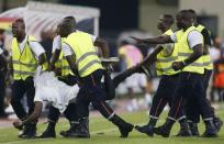 Security detain an Equatorial Guinea fan on the pitch after he tried to attack the referee during the 2015 African Cup of Nations semi-final soccer match against Ghana in Malabo, February 5, 2015. REUTERS/Amr Abdallah Dalsh