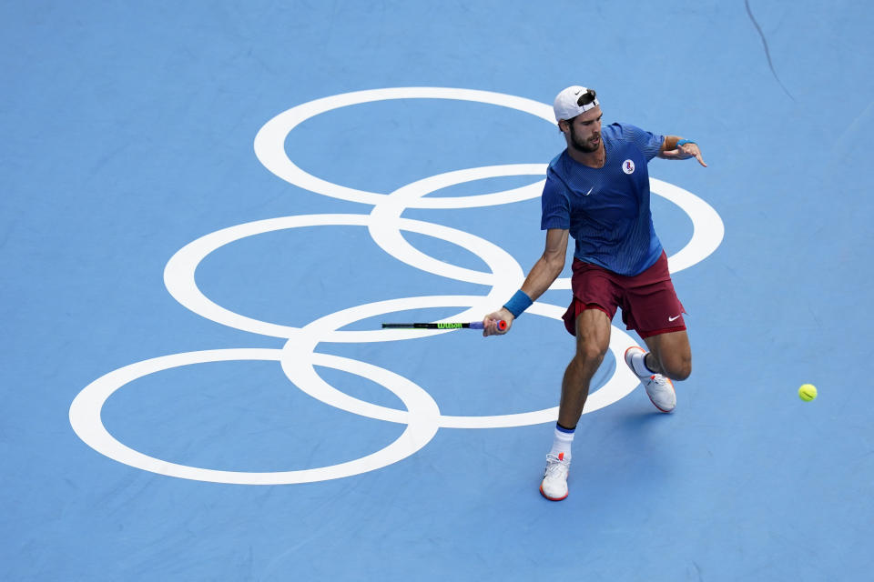 Karen Khachanov, of the Russian Olympic Committee, returns to Pablo Carreno Busta, of Spain, during the semifinal round of the men's tennis competition at the 2020 Summer Olympics, Friday, July 30, 2021, in Tokyo, Japan. (AP Photo/Patrick Semansky)