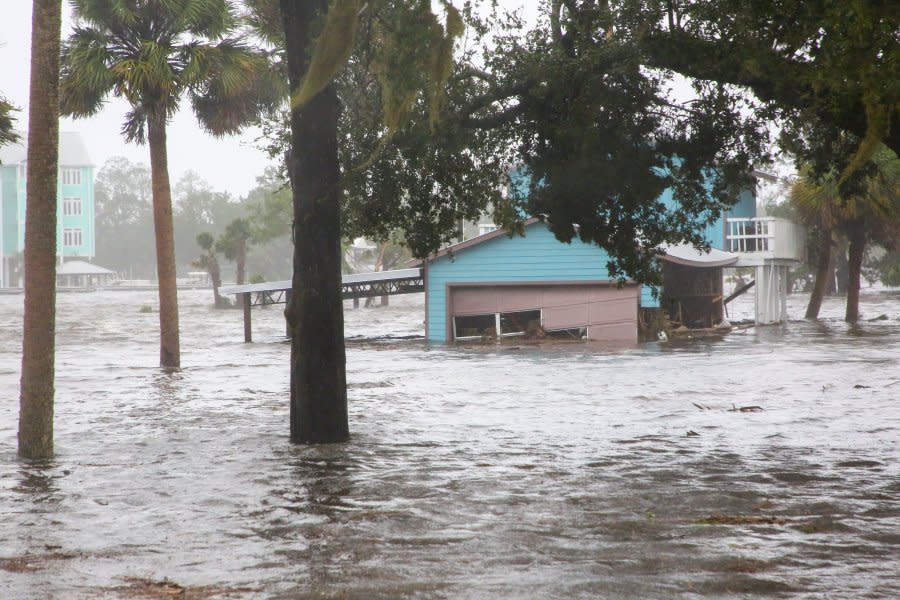 Storm surge floods a home off Riverside Drive on the Steinhatchee River in Steinhatchee, Fla., on Wednesday, Aug 30, 2023. Hurricane Idalia made landfall Wednesday in Florida as a Category 3 storm and unleashed devastation along a wide stretch of the Gulf Coast, submerging homes and vehicles, turning streets into rivers, unmooring small boats and downing power lines before sweeping into Georgia. (Douglas R. Clifford/Tampa Bay Times via AP)