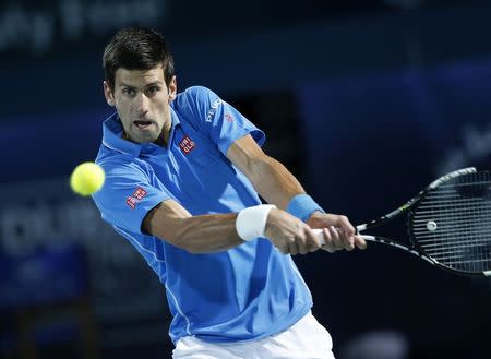 Novak Djokovic of Serbia returns the ball to Tomas Berdych of Czech Republic during their semi-final match at the ATP Championships tennis tournament in Dubai, February 27, 2015. REUTERS/Ahmed Jadallah