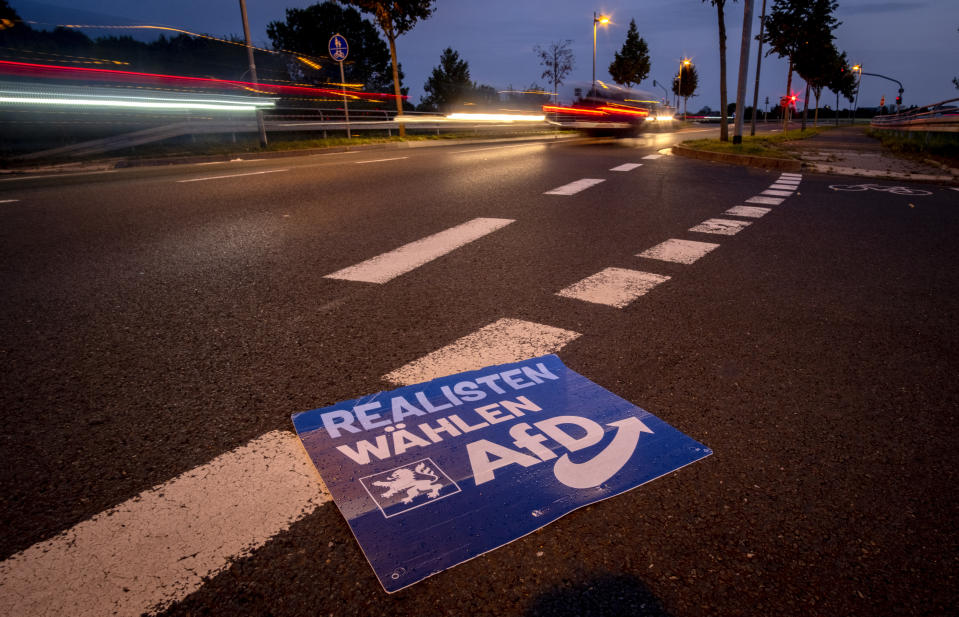 An election poster of right wing party AfD lies on the street during the Hesse federal state election in Frankfurt, Germany, Sunday, Oct. 8, 2023. Hesse election were held on Sunday. (AP Photo/Michael Probst)