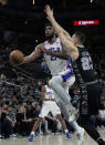 Philadelphia 76ers center Joel Embiid (21) drives to the basket against San Antonio Spurs forward Zach Collins (23) during the first half of an NBA basketball game in San Antonio, Friday, Feb. 3, 2023. (AP Photo/Eric Gay)