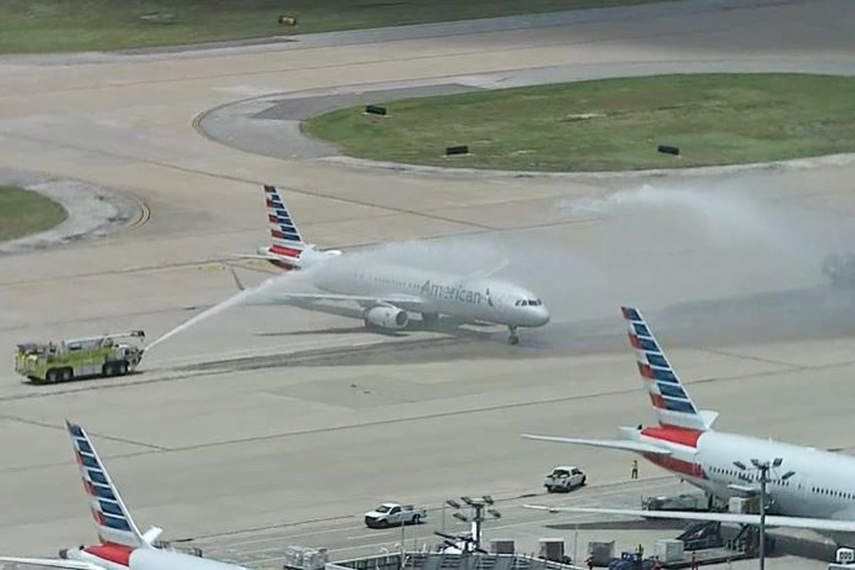 A plane carrying Elijah Snow's remains is saluted by firetrucks at Dallas-Fort Worth International Airport. (NBC5 DFW)