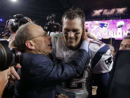 New England Patriots quarterback Tom Brady is congratulated by team president Jonathan Kraft after defeating the Seattle Seahawks in the NFL Super Bowl XLIX football game in Glendale, Arizona February 1, 2015. REUTERS/Brian Snyder