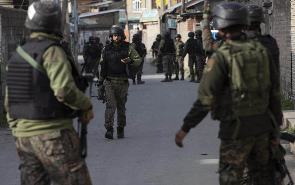 Indian soldiers arrive at the site of an attack on the outskirts of Srinagar, Indian controlled Kashmir, Thursday, March 25, 2021. Rebels fighting against Indian rule in disputed Kashmir Thursday attacked a paramilitary patrol, killing two soldiers and injuring two others, an official said. (AP Photo/Mukhtar Khan)