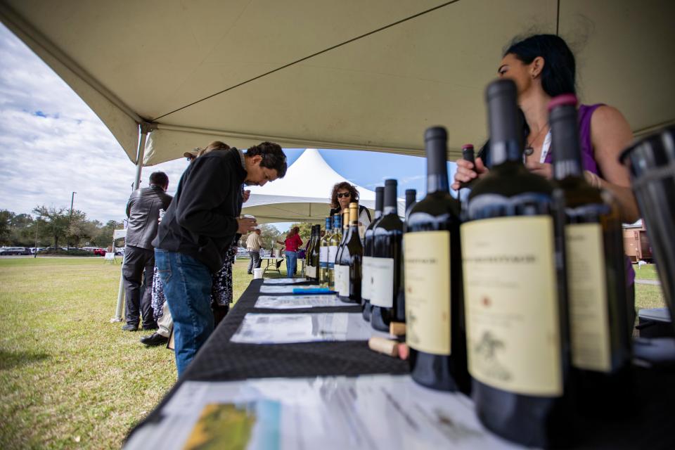 Attendees enjoy samples of wine and beer as well as small bites of food during this year's Cleaver and Cork event at Tallahassee Community College Saturday, March, 6, 2021.