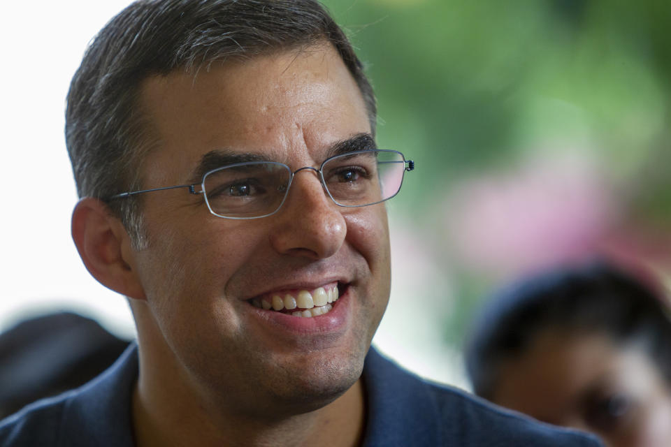 FILE - In this Aug. 21, 2019, file photo Rep. Justin Amash, I-Cascade Township, holds a constituent meeting at Rising Grinds Cafe, in Grand Rapids, Mich. Amash, a Trump critic, said Saturday, May 16, 2020, that he has decided not to seek the Libertarian nomination to run for president. (Cory Morse/The Grand Rapids Press via AP, File)