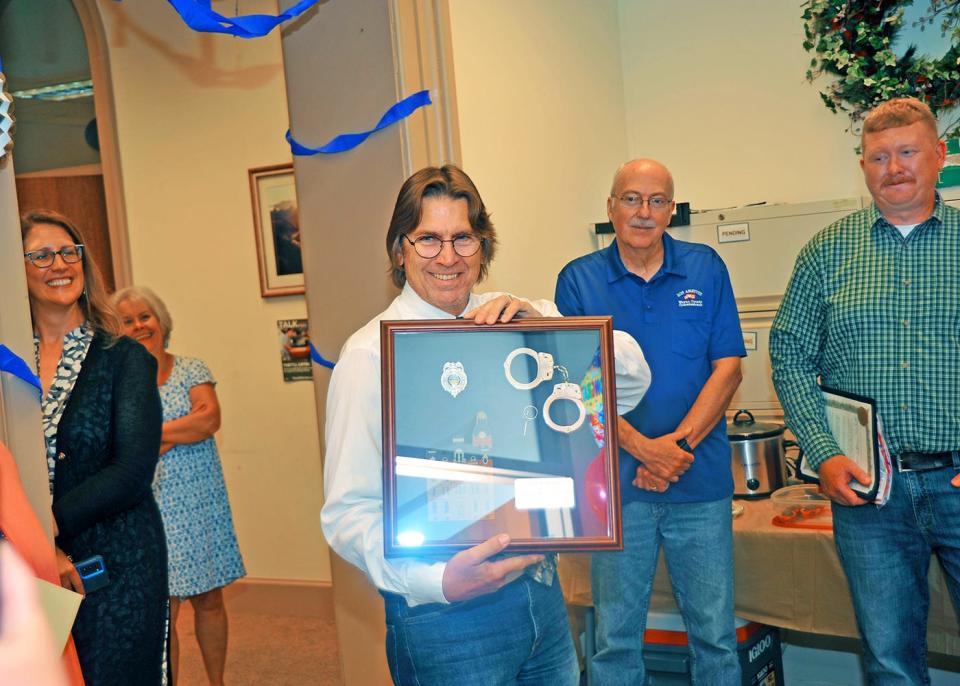 Mark Russell celebrates retirement after 32 years of service as a Wayne County juvenile probation officer.