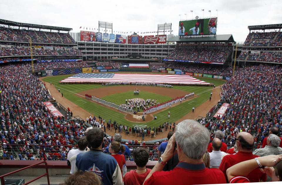 FILE - The Fort Worth Symphony Orchestra performs at Globe Life Park before an opening day baseball game between the Texas Rangers and the Philadelphia Phillies in Arlington, Texas, March 31, 2014. Major League Baseball is playing its All-Star Game in Arlington for the first time since 1995, when the Rangers played outside in the stifling heat. This year's game will be played Tuesday, July 16, 2024, in their stadium with a retractable roof that opened in 2020. (AP Photo/Kim Johnson Flodin, File)