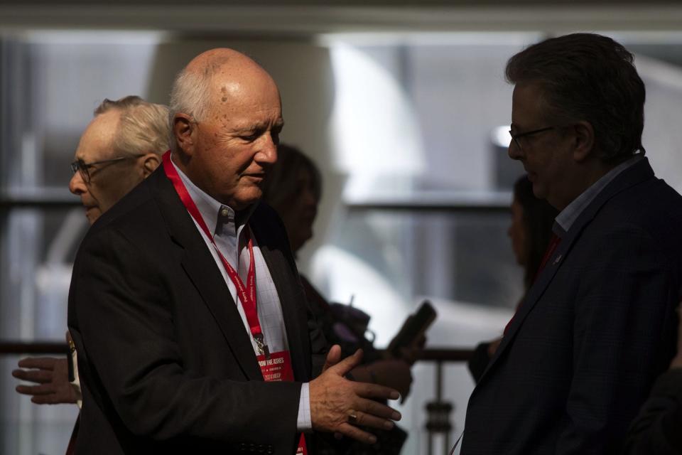 Former U.S. Rep. Pete Hoekstra, left,, the new chairman of the Michigan Republican Party, has a conversation at the Michigan GOP state convention on March 2, 2024, in Grand Rapids, Michigan.