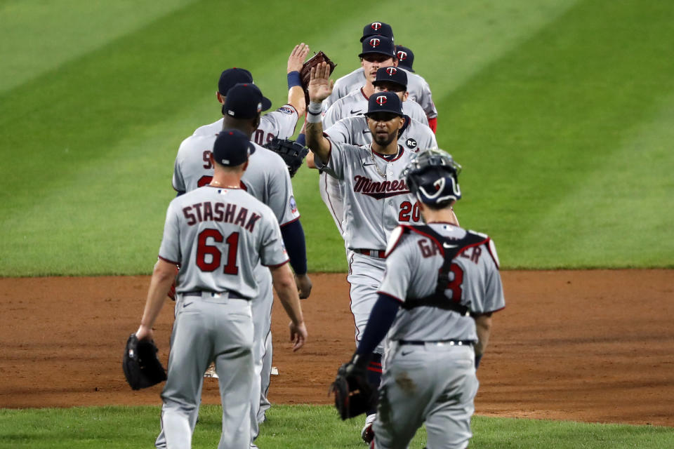 The Minnesota Twins celebrate the team's 10-5 win over the Chicago White Sox after a baseball game, Friday, July 24, 2020, in Chicago. (AP Photo/Charles Rex Arbogast)