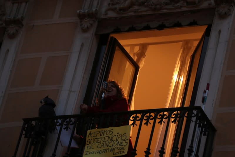 Spanish blues singer "Betta" sings from her balcony during a daily evening concert to support health workers and to make it easier for her neighbours to bear the coronavirus lockdown in Madrid