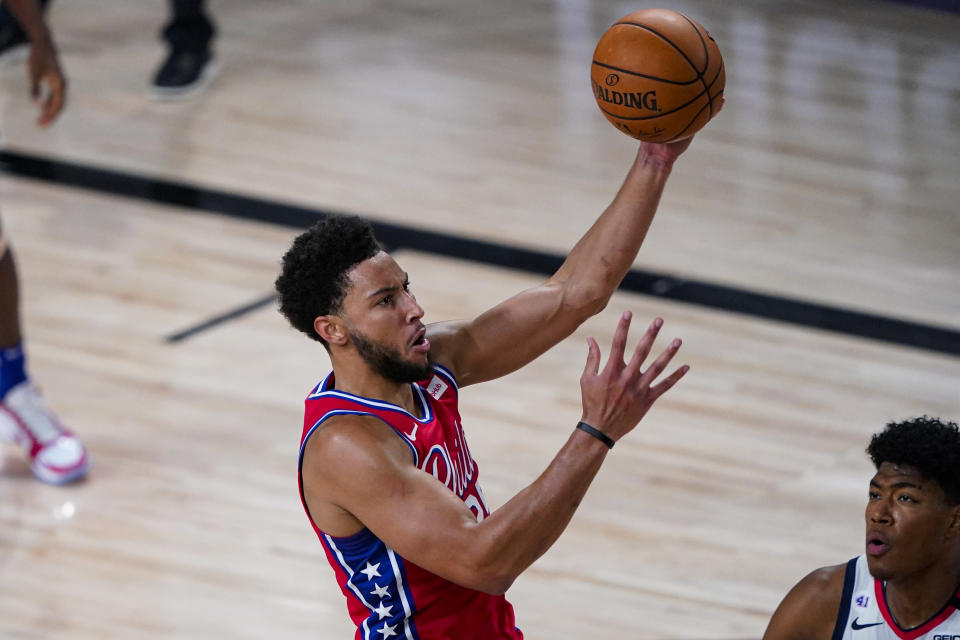 Philadelphia 76ers guard Ben Simmons (25) shoots over Washington Wizards forward Rui Hachimura (8) during the second half of an NBA basketball game Wednesday, Aug. 5, 2020 in Lake Buena Vista, Fla. (AP Photo/Ashley Landis)