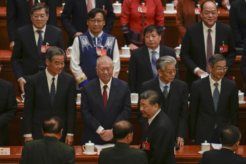 Chinese President Xi Jinping, bottom center, leaves after the opening session of the National People's Congress (NPC) at the Great Hall of the People in Beijing, China, Tuesday, March 5, 2024. (AP Photo/Ng Han Guan)